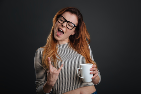 Confident active girl rocking morning coffeeの写真素材