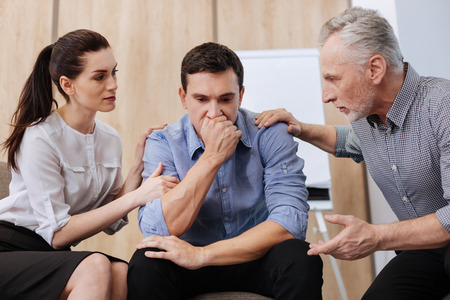 Cheerless handsome man feeling depressedの写真素材