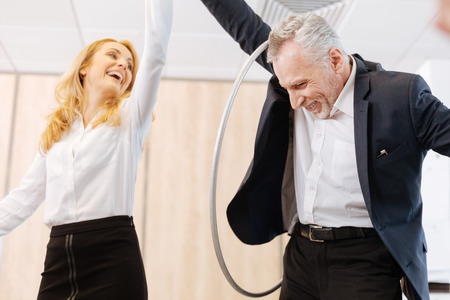 Happy joyful man holding a hula hoopの写真素材