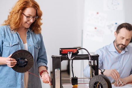 Nice delighted woman holding a filament coil