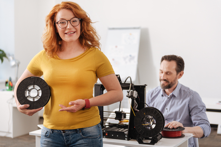 Happy delighted woman showing you 3d filament