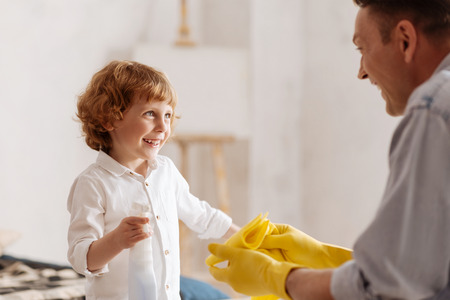 Portrait of handsome kid while joking with fatherの写真素材
