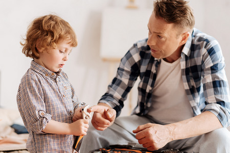 Serious man talking to his little son