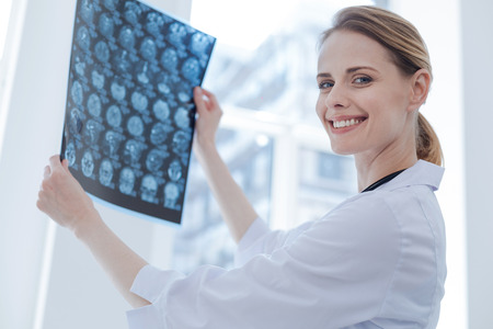 Glad x ray specialist examining radiograph results at the laboratory