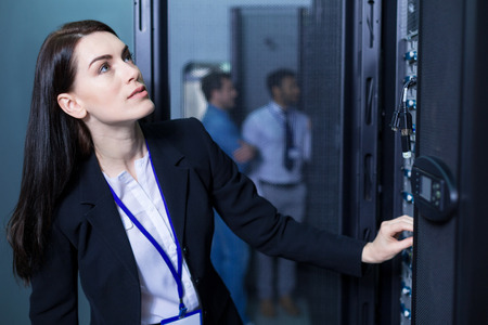 Serious intelligent woman working with informational technologyの写真素材