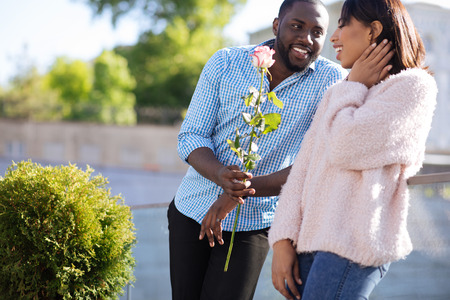 Gallant handsome guy surprising his girlfriendの写真素材
