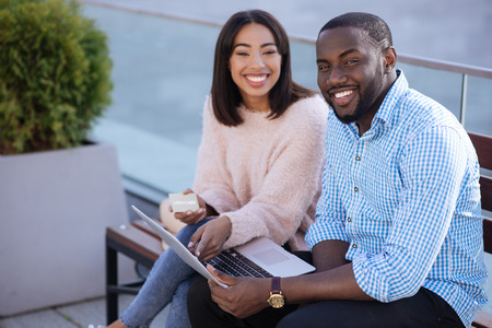 Sweet positive couple deciding making an online purchaseの写真素材