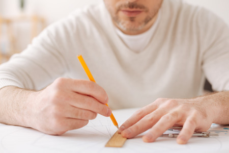 Close up of serious man that working at interesting sketch