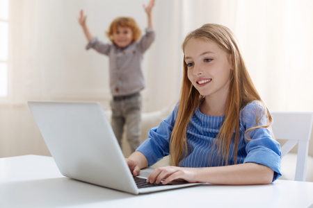Enthusiastic pretty girl preparing essay for tomorrowの写真素材