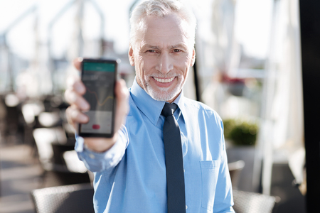 Mature male person keeping smile on his faceの写真素材