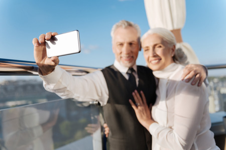 Happy people smiling while taking photoの写真素材