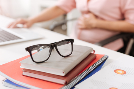 Selective focus of glasses lying on table in the officeの写真素材