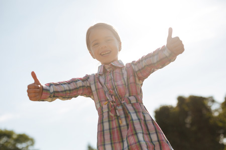 Happy kid actively expressing positivityの写真素材