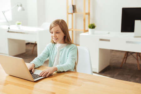 Focused diligent girl working with her laptopの写真素材
