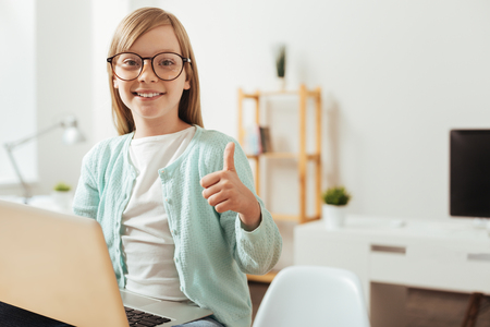 Inventive productive child making an approving gestureの写真素材