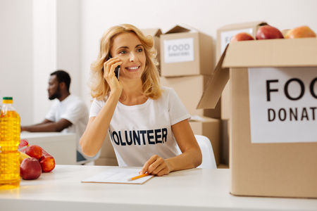 Active productive woman calling from charitable organization officeの写真素材