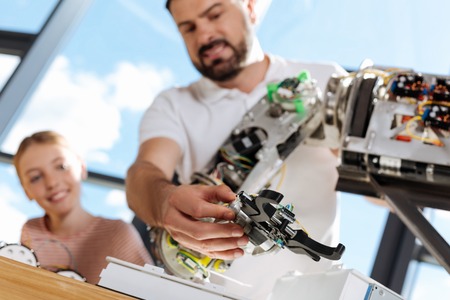 Pleasant man checking the performance of hand mechanismの写真素材