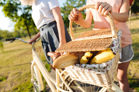Close up of a picnic basket in hands of a young girlの写真素材