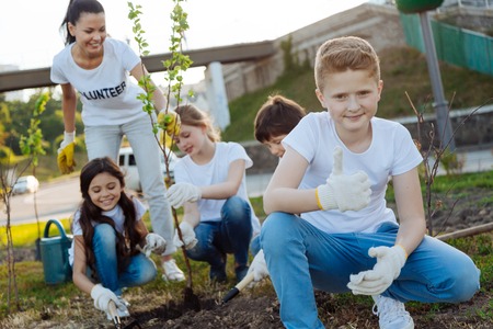 Confident blonde boy raising his thumb upの写真素材