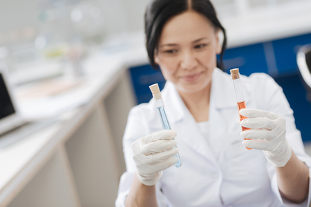Nice good looking woman holding chemical reagentsの写真素材