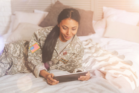 Beautiful military woman using a tabletの写真素材