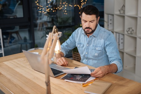 Hard working handsome businessman working with documentsの写真素材