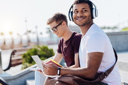 Positive brunette male listening musicの写真素材