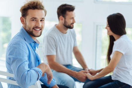 Positive delighted man turning to youの写真素材