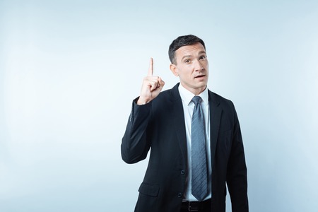 Nice handsome man pointing with his fingerの写真素材
