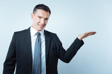 Nice cheerful businessman looking at youの写真素材