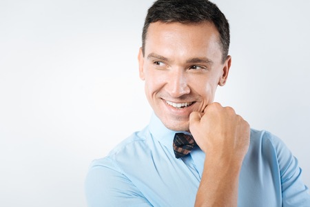 Joyful cheerful man looking asideの写真素材