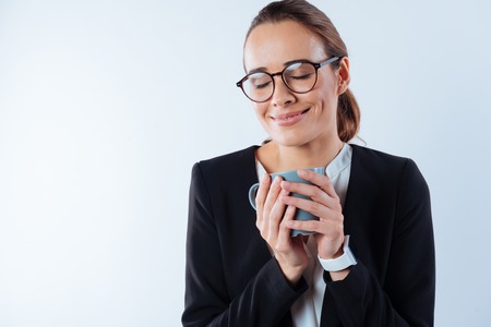 Delighted dreamy woman closing her eyesの写真素材
