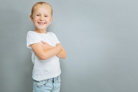 Charming girl crossing arms on chestの写真素材