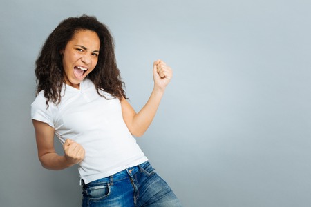 Successful young woman making fistsの写真素材