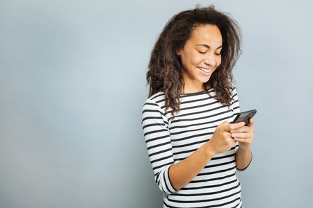 Positive delighted woman showing friendly smile