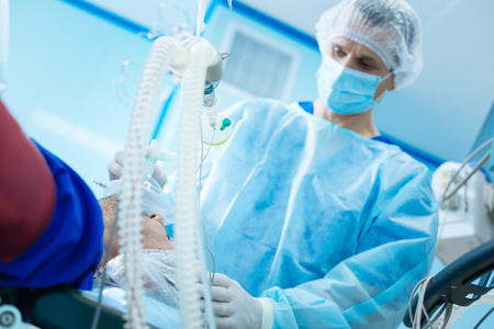 Attentive doctor helping his patientの写真素材