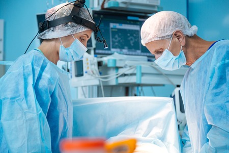 Competent surgeons doing complex operationの写真素材