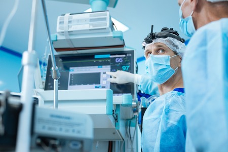 Competent medical worker pointing at his equipmentの写真素材