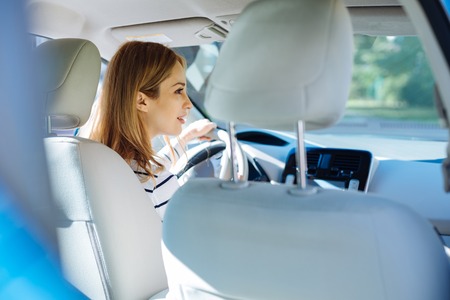 Smart nice woman sitting in the car