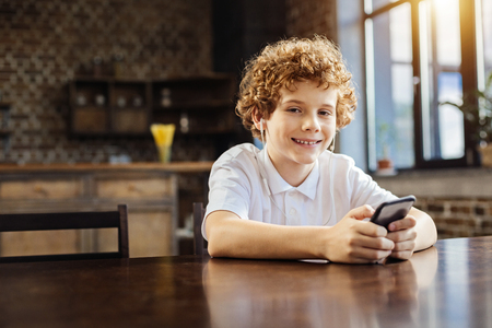 Happy preteen boy listening to music at homeの写真素材
