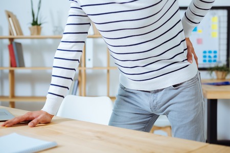 Close up of male person that leaning on table