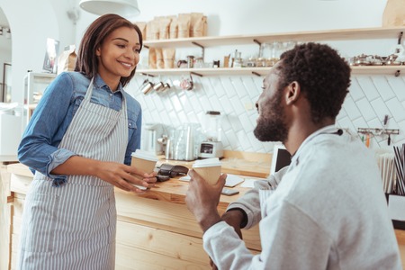 Upbeat baristas chatting during break from workの写真素材