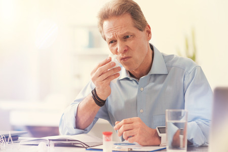 Sick mature man suffering from an allergyの写真素材