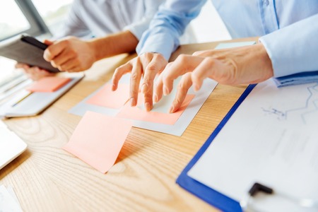 Close up of female hands that gluing papers