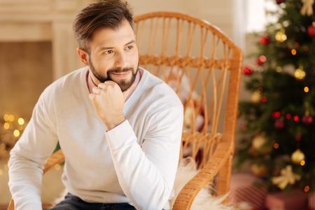 Handsome man sitting in a rocking chairの写真素材