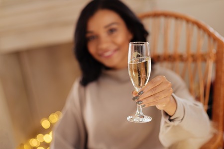 Smiling woman holding a glass of champagneの写真素材