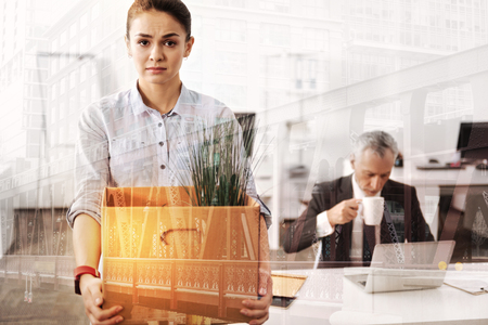 Cheerless sad woman bagging for a new job positionの写真素材