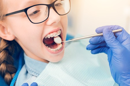 Close up of schoolgirl with braces attending stomatologist