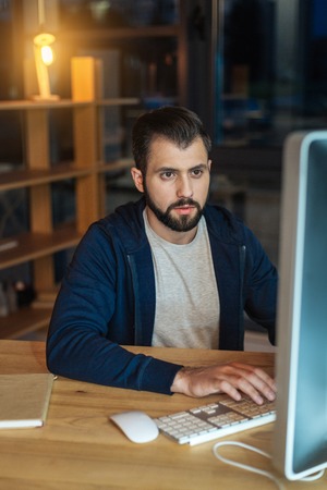 Serious brunette working with computer