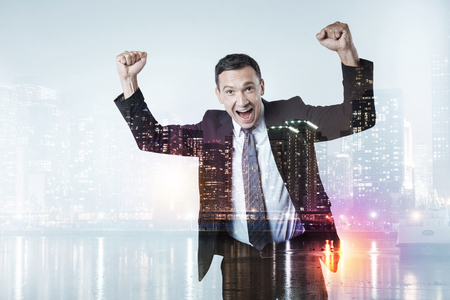Happy businessman raising fists upの写真素材